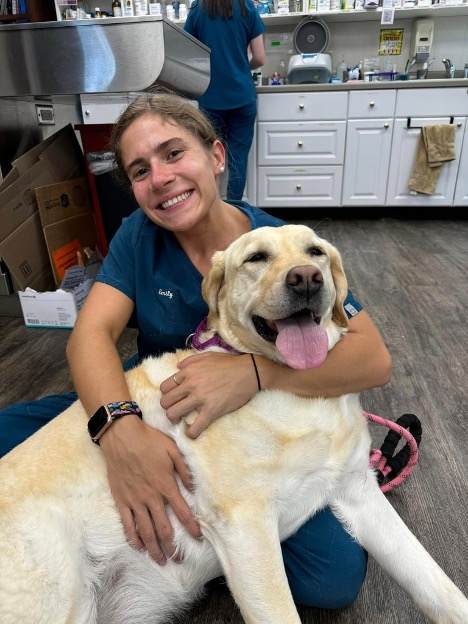 vet tech with happy dog
